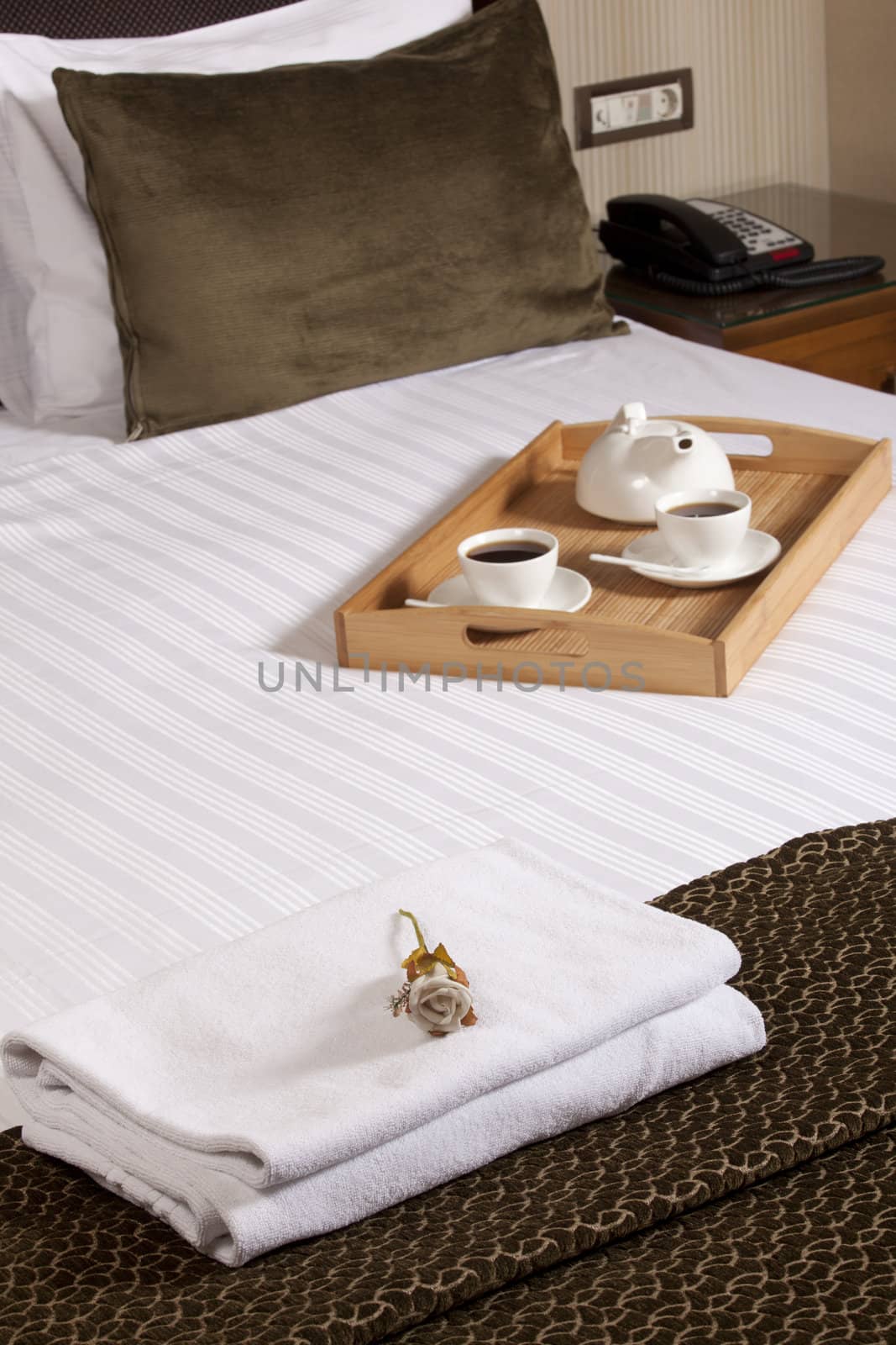 Tray with coffee on a bed in a hotel room
