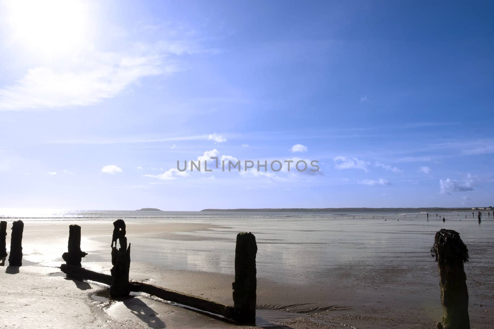 sunshine over the beach breakers in Youghal county Cork Ireland on a summers day
