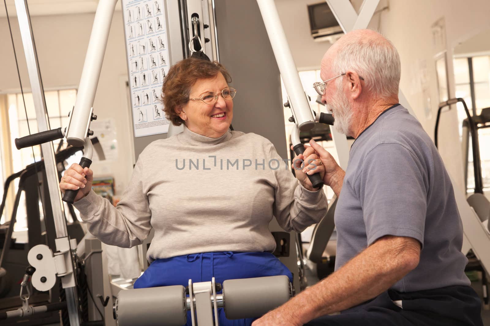 Active Senior Adult Couple Working Out Together in the Gym.