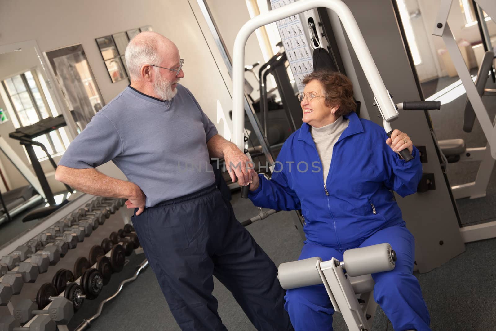 Active Senior Adult Couple Working Out Together in the Gym.