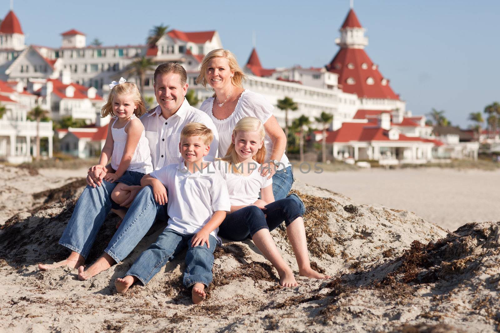 Happy Caucasian Family in Front of Hotel Del Coronado, U.S.A., on a Sunny Afternoon.