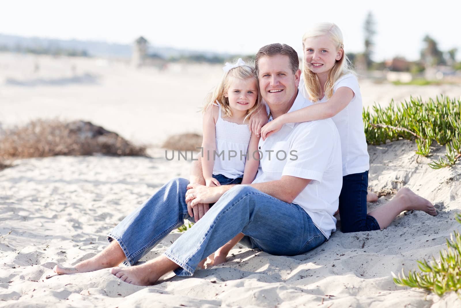 Handsome Dad and His Cute Daughters Portrait at The Beach