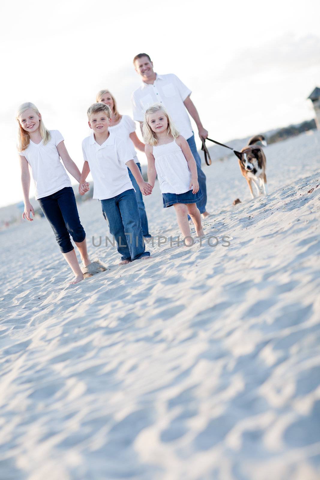 Adorable Children and Family on a Walk at the Beach.