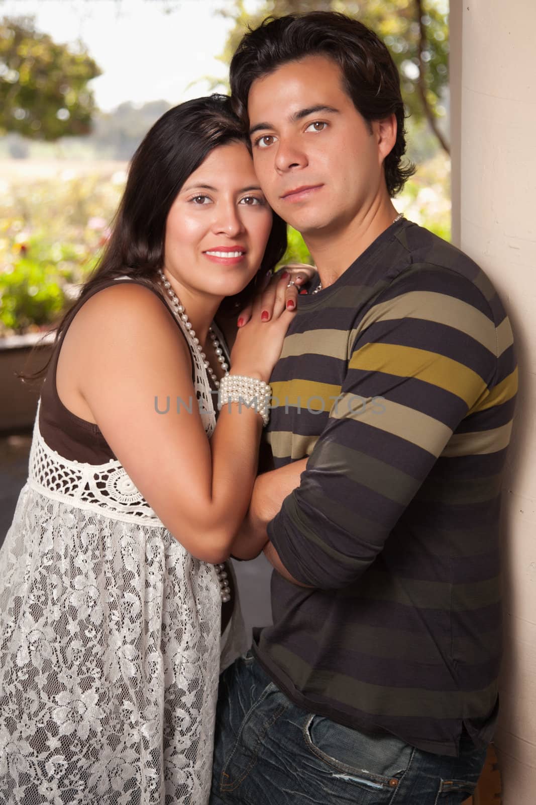 Attractive Hispanic Couple Portrait Enjoying Each Other Outdoors.