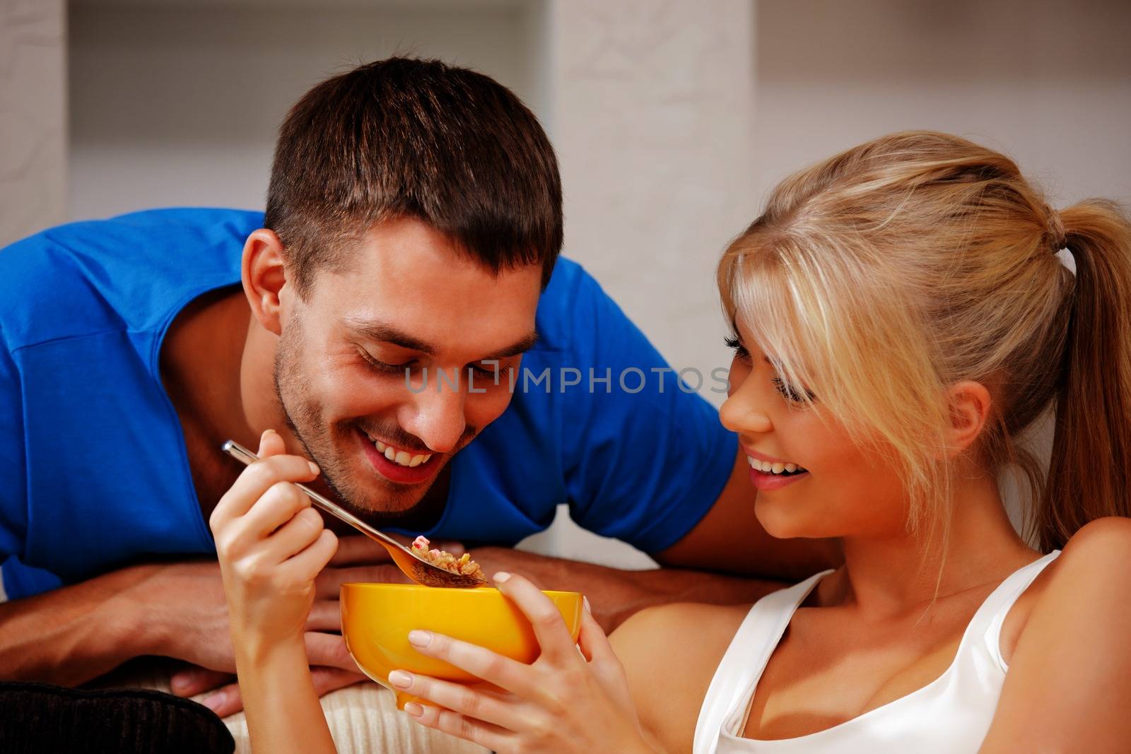 bright picture of happy couple with muesli (focus on man)