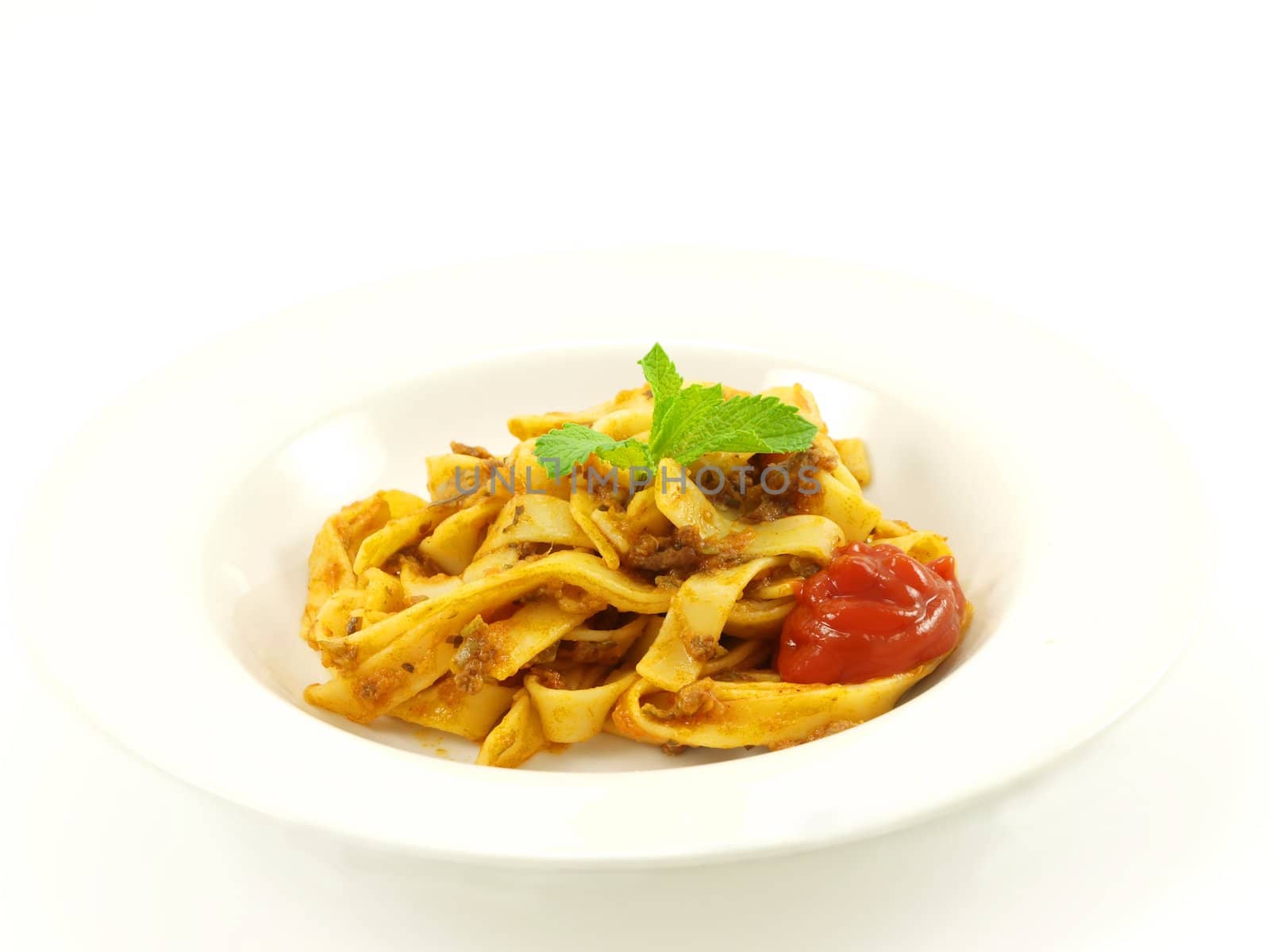 Pasta with meat sauce on towards white background