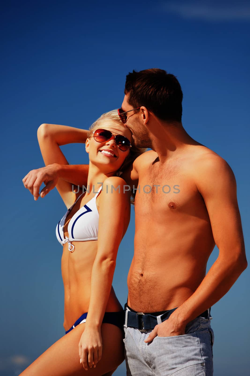 picture of happy couple in sunglasses on the beach.