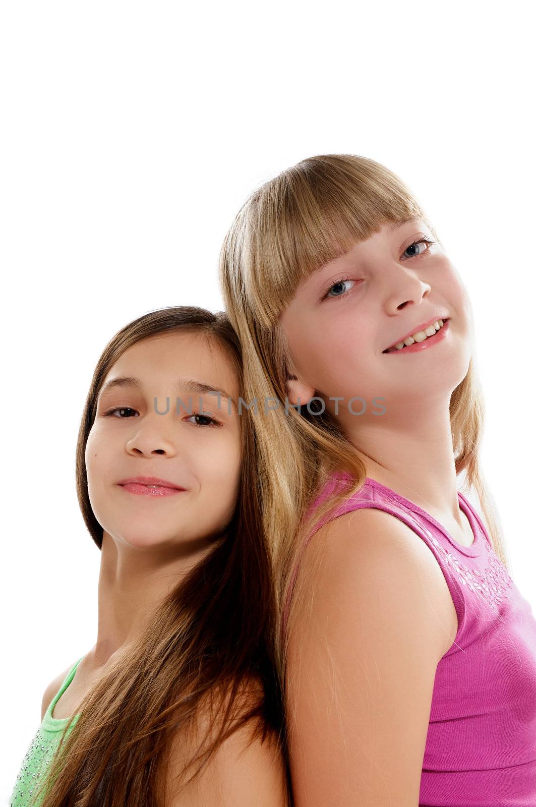 Two Happy Girls Standing Back to Back and Smiling isolated on white background
