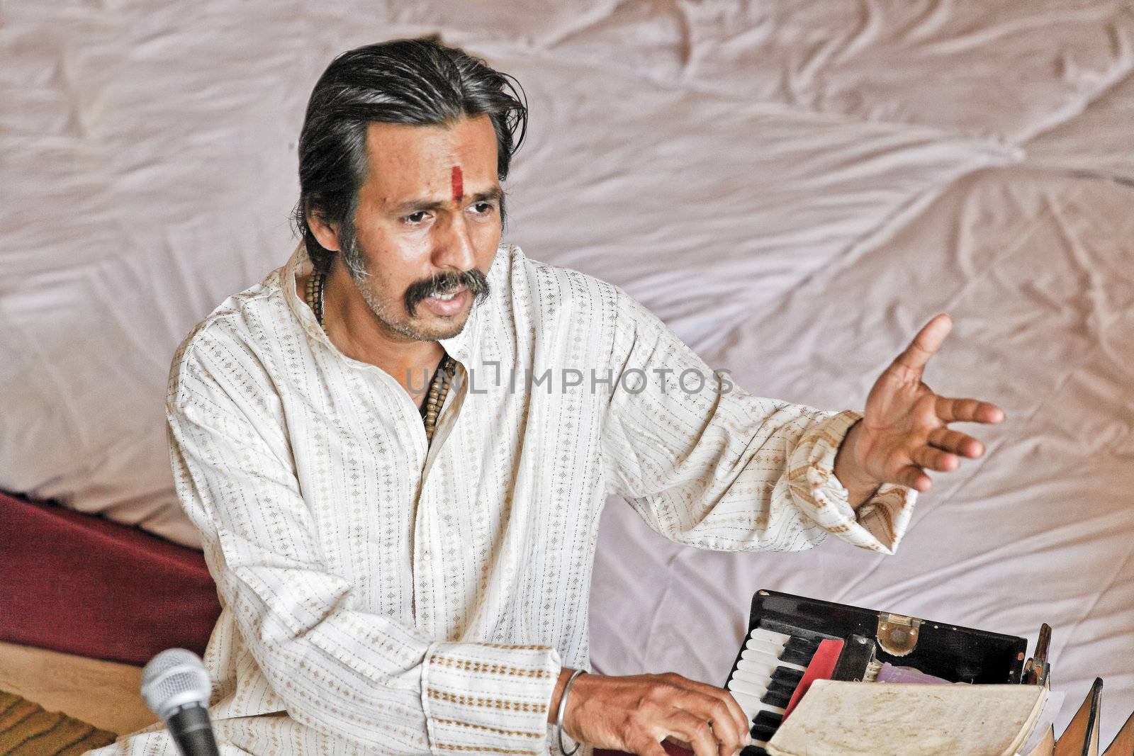 Manoj Desai, Bombay musician, singer and harmonium player rehearsing before a performance at a private venue in Bombay, April 2012