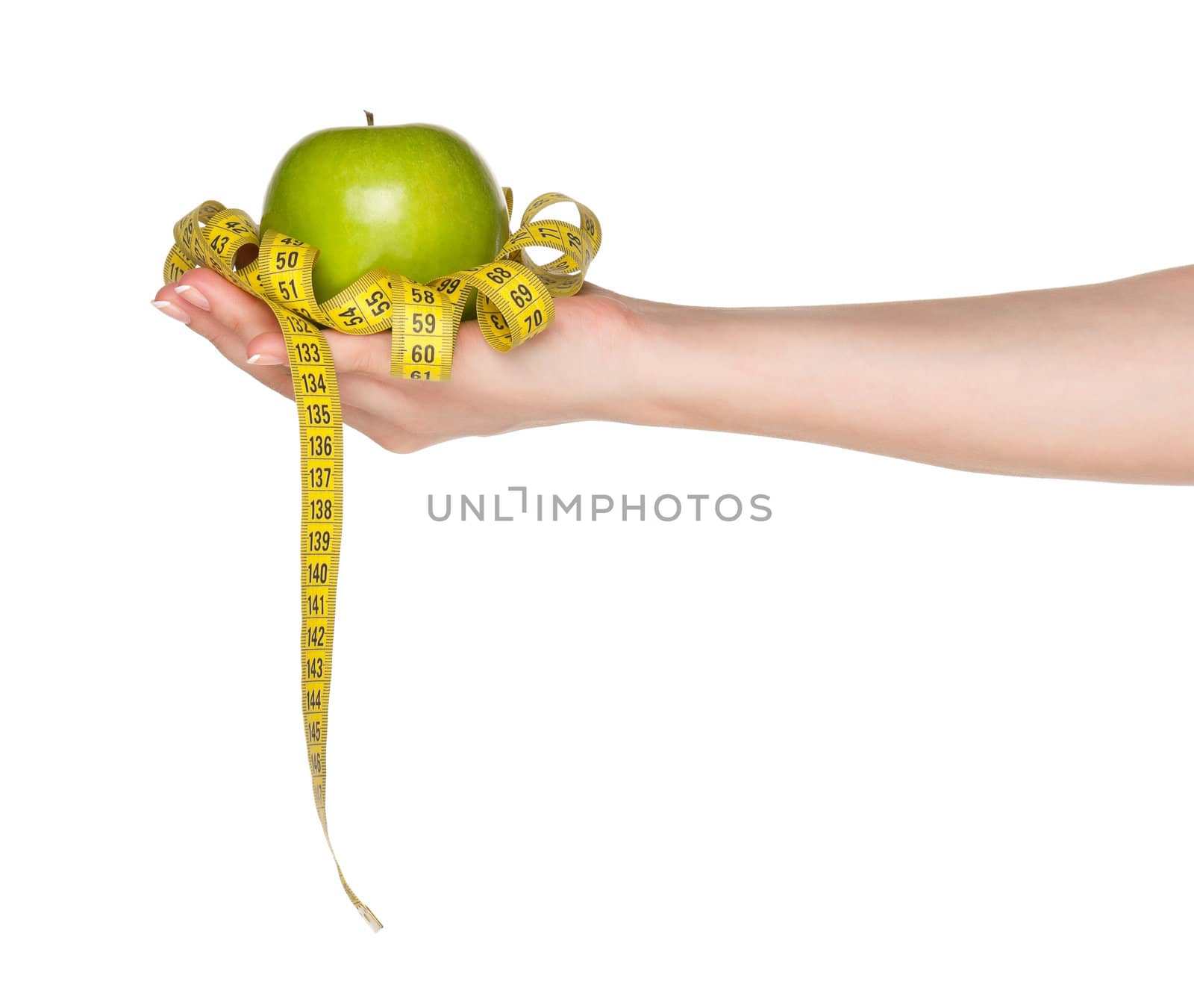 Woman hand with green apple and measure tape isolated on white background