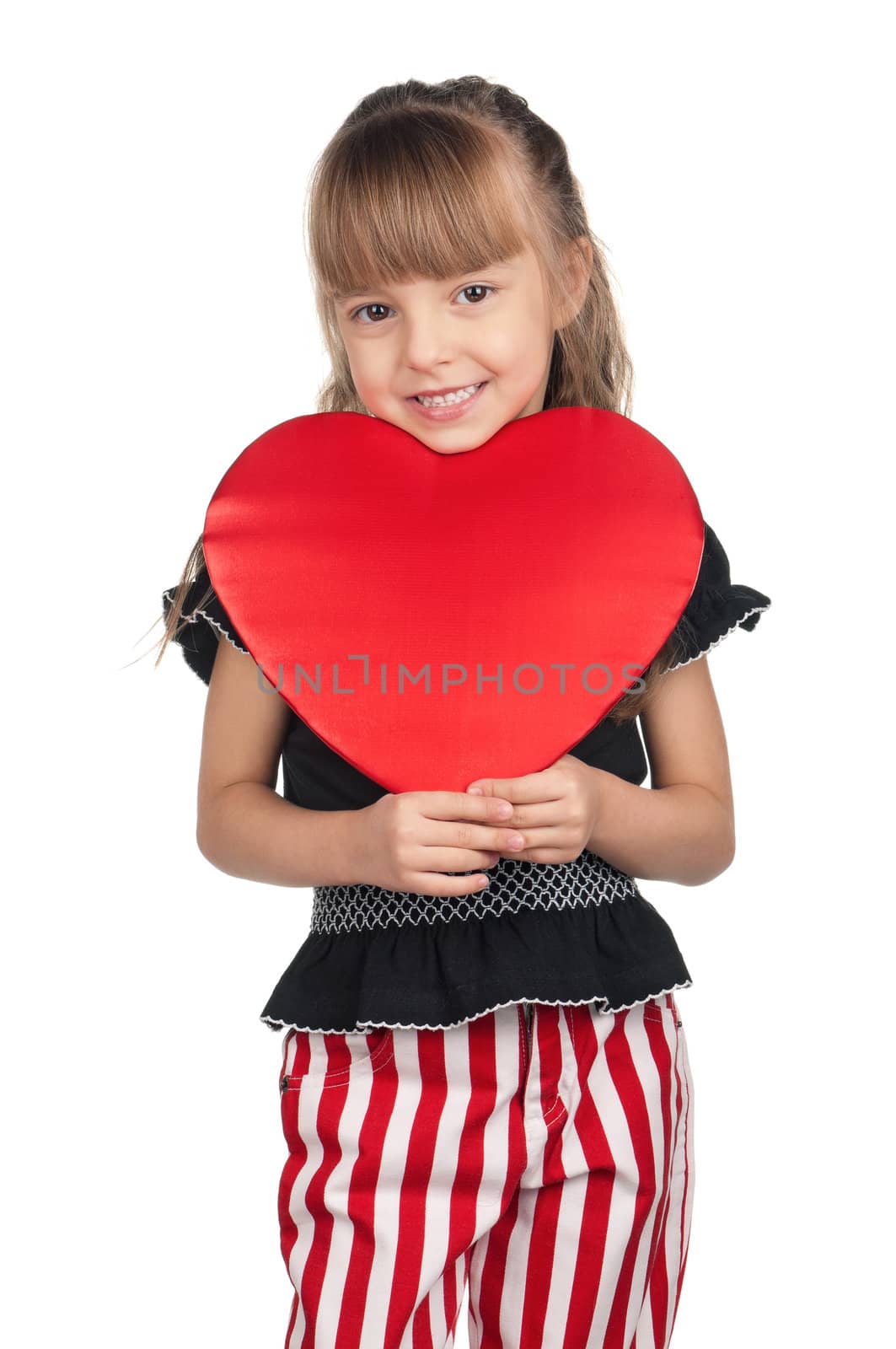 Portrait of little girl holding red heart over white background