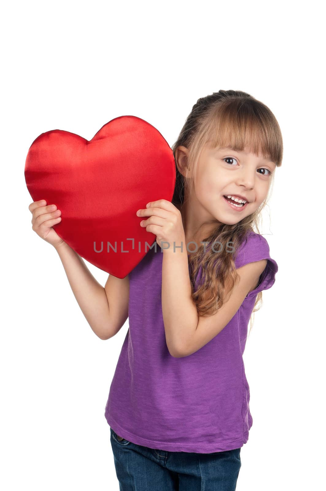 Portrait of little girl holding red heart over white background