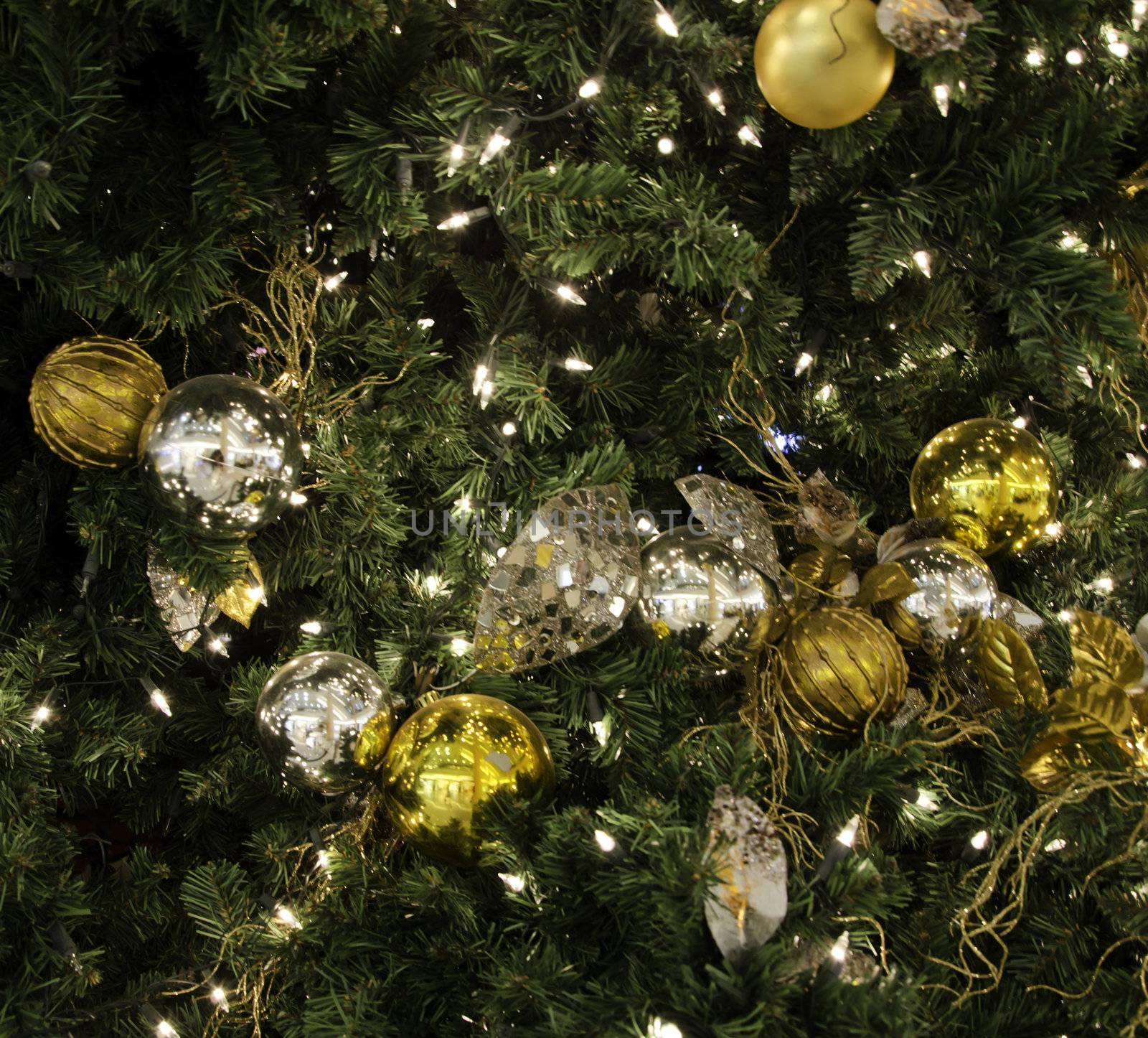 Glittering silver and white Christmas tree decorations by a warm fire 