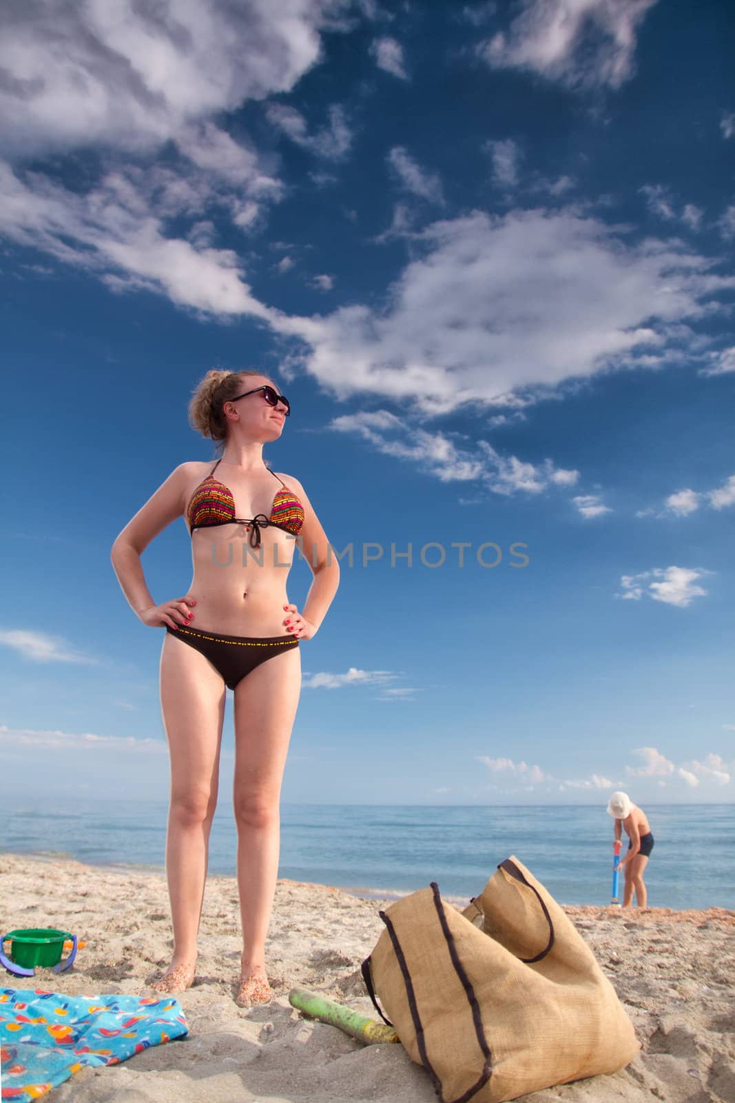 white woman with a child sunning by the sea