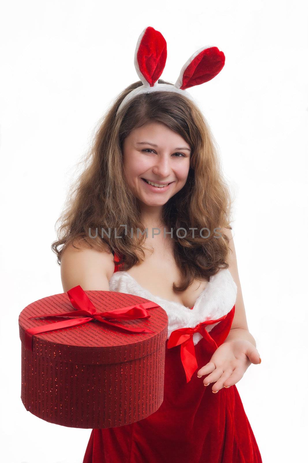 young christmas woman in red santa claus dress is giving a christmas present 