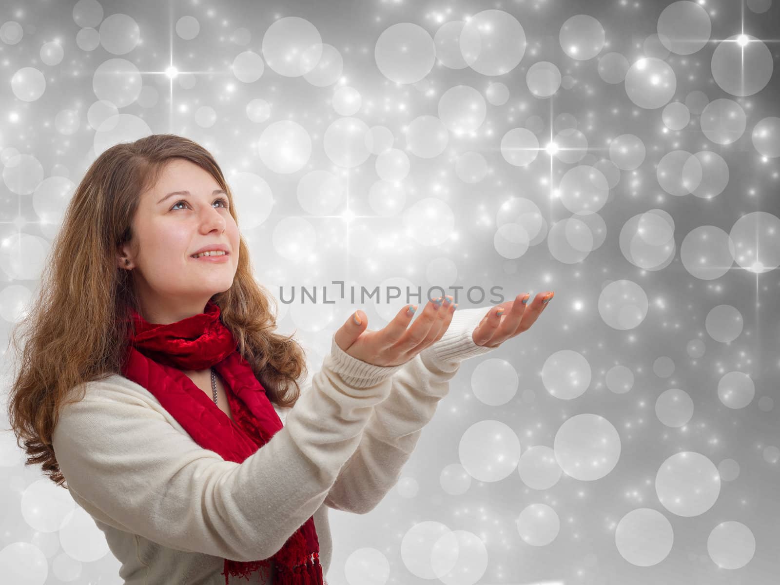 Winter woman holding hands up on grey background with stars and snowflakes