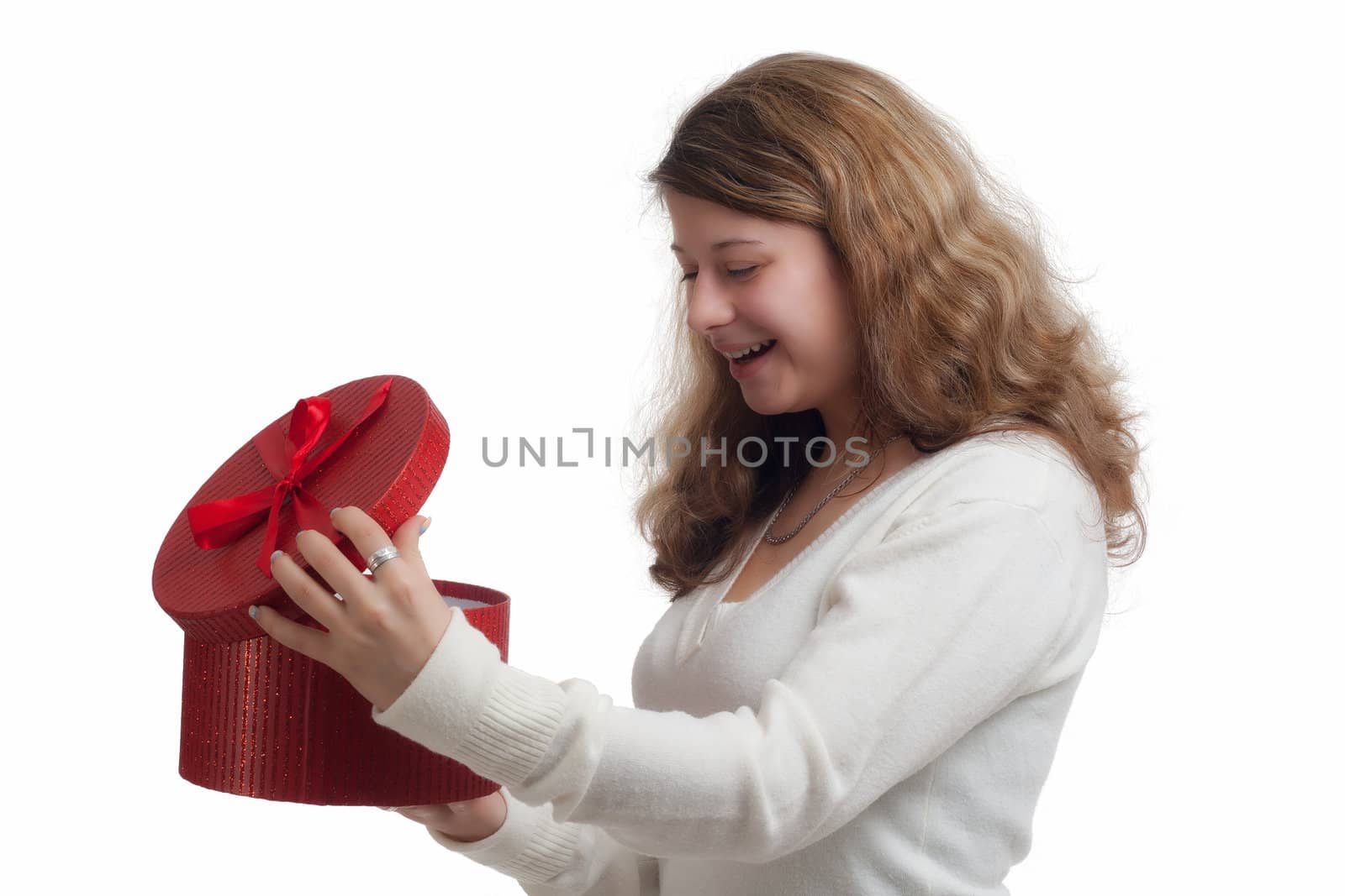 beautiful smiling blond woman opens a red gift box isolated on white 