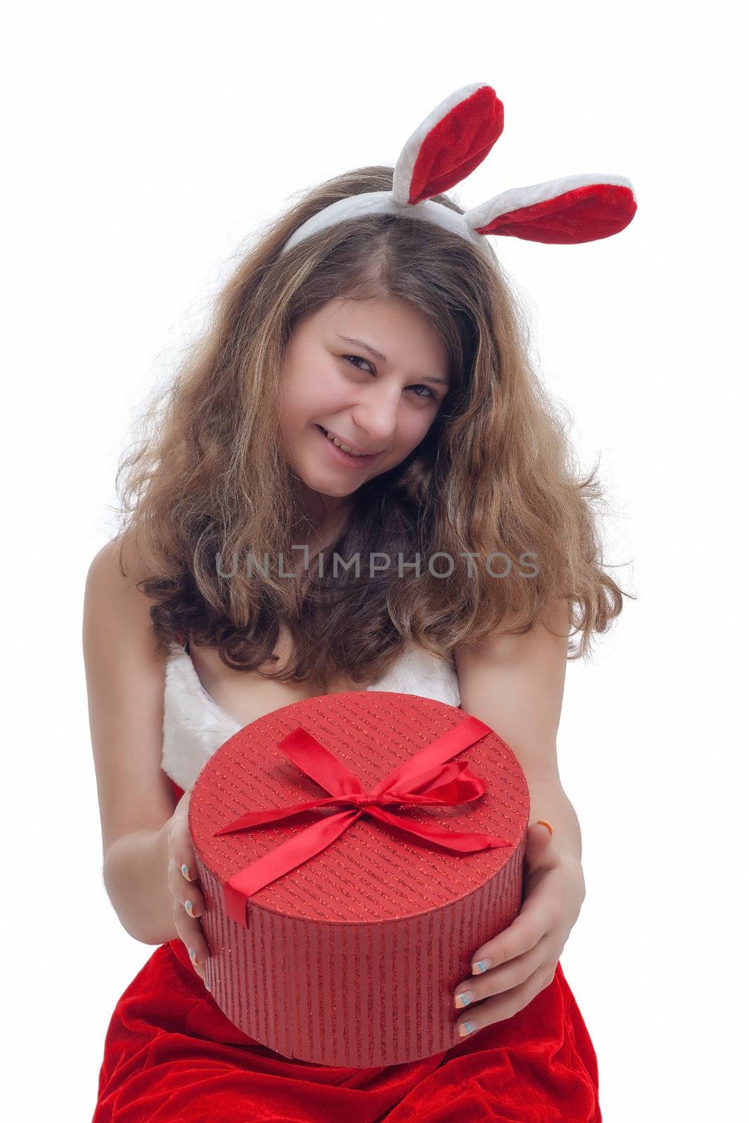 young christmas woman in red santa claus dress is holding a christmas present 