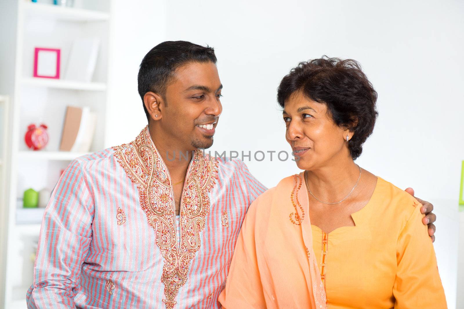 Indian mature mother talking with her adult son at home