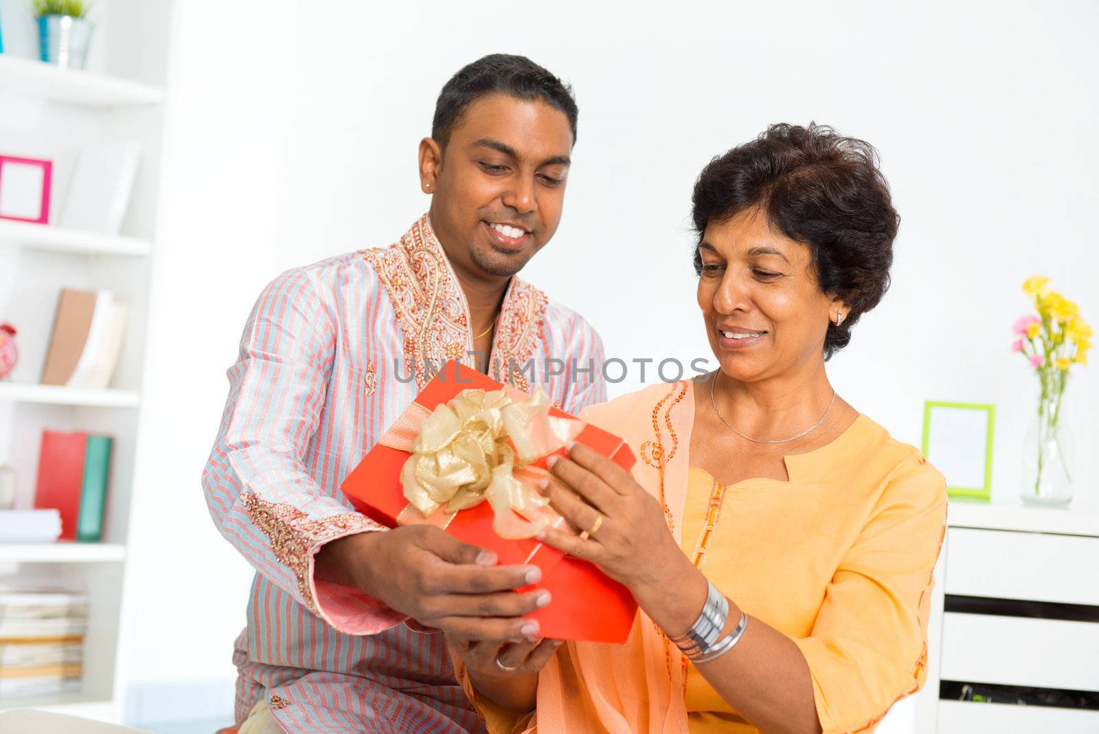 Mature Indian woman receiving a gift from her son