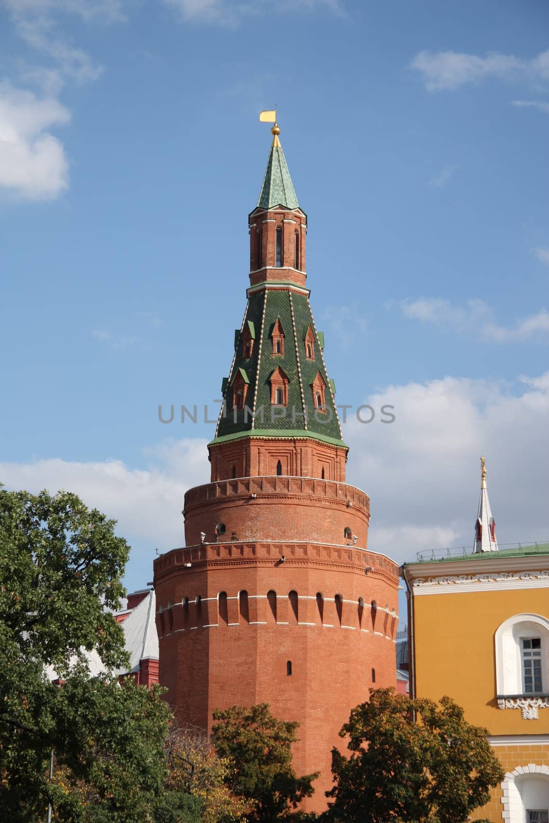 The Angle Arsenal tower (Arsenalnaya Tower) of Kremlin wall over blue cloudy sky, Moscow, Russia