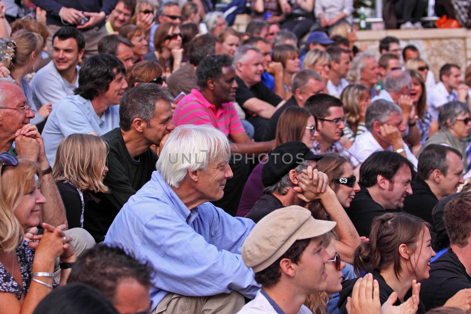BRISTOL, ENGLAND - JULY 31: Audience watching musicians perform on the Cascade Steps stage at the Harbour Festival in Bristol, England on July 31, 2010