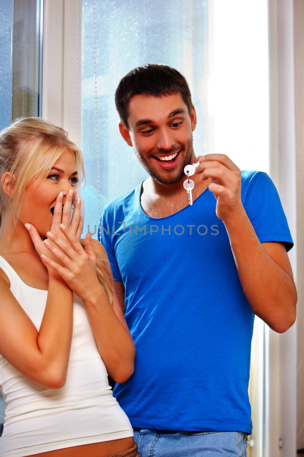 happy couple with keys by dolgachov