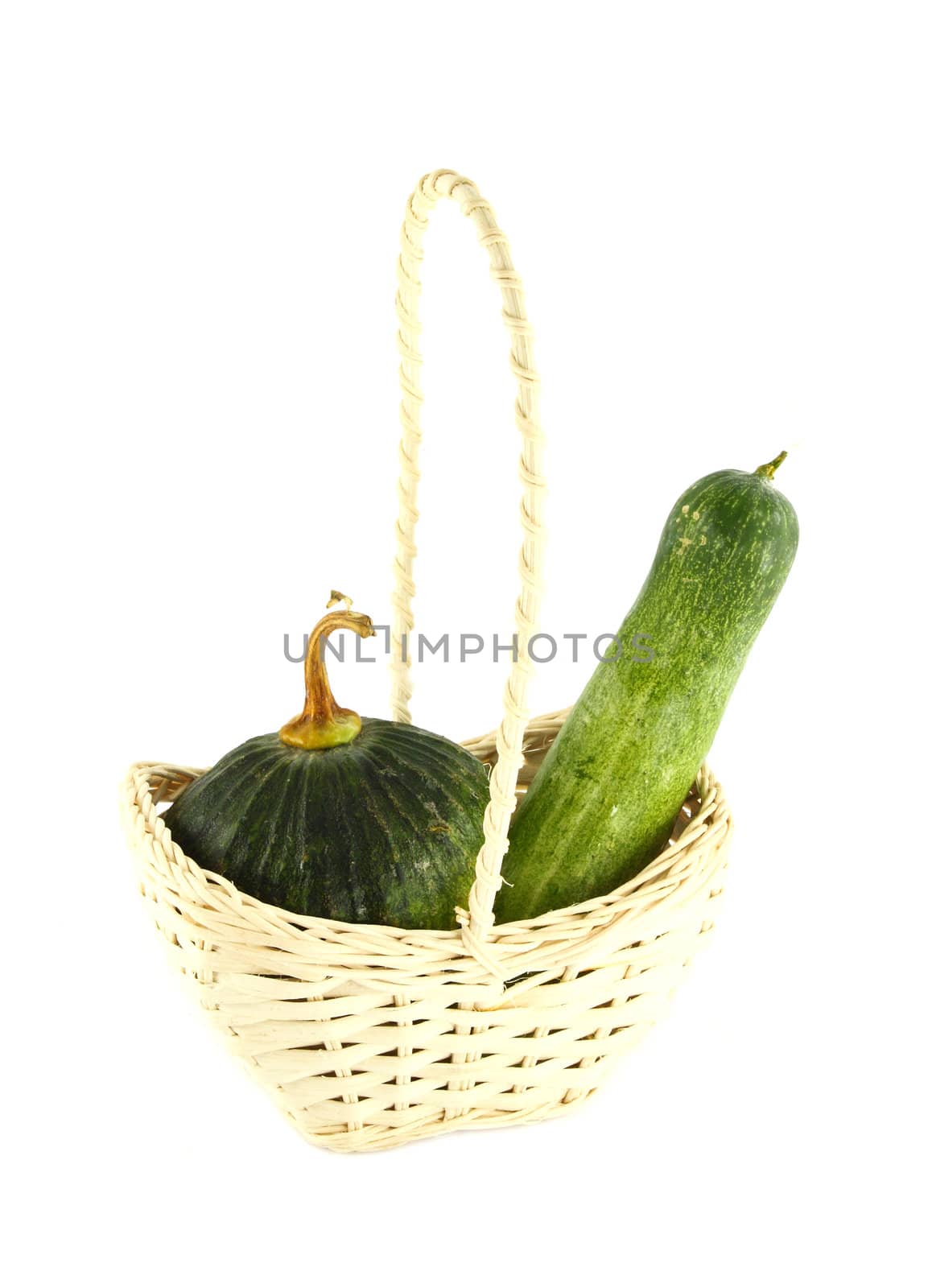 Cucumber and Pumpkin in wicker basket on white by geargodz