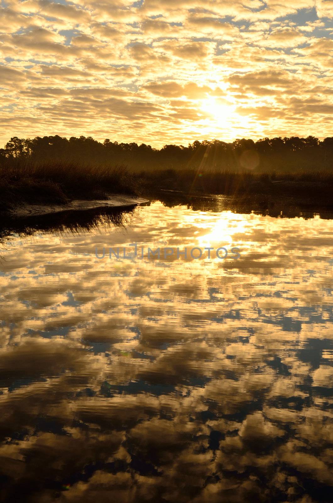 Clouds dominate a sunrise over Borrell Creek in Saint Marys, Georgia, Photo by Jackie DeBusk