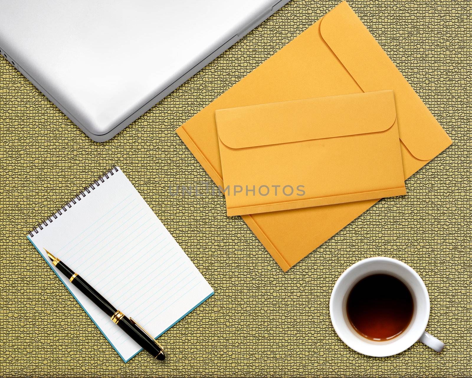 business desktop with laptop, notepad, envelops and coffee