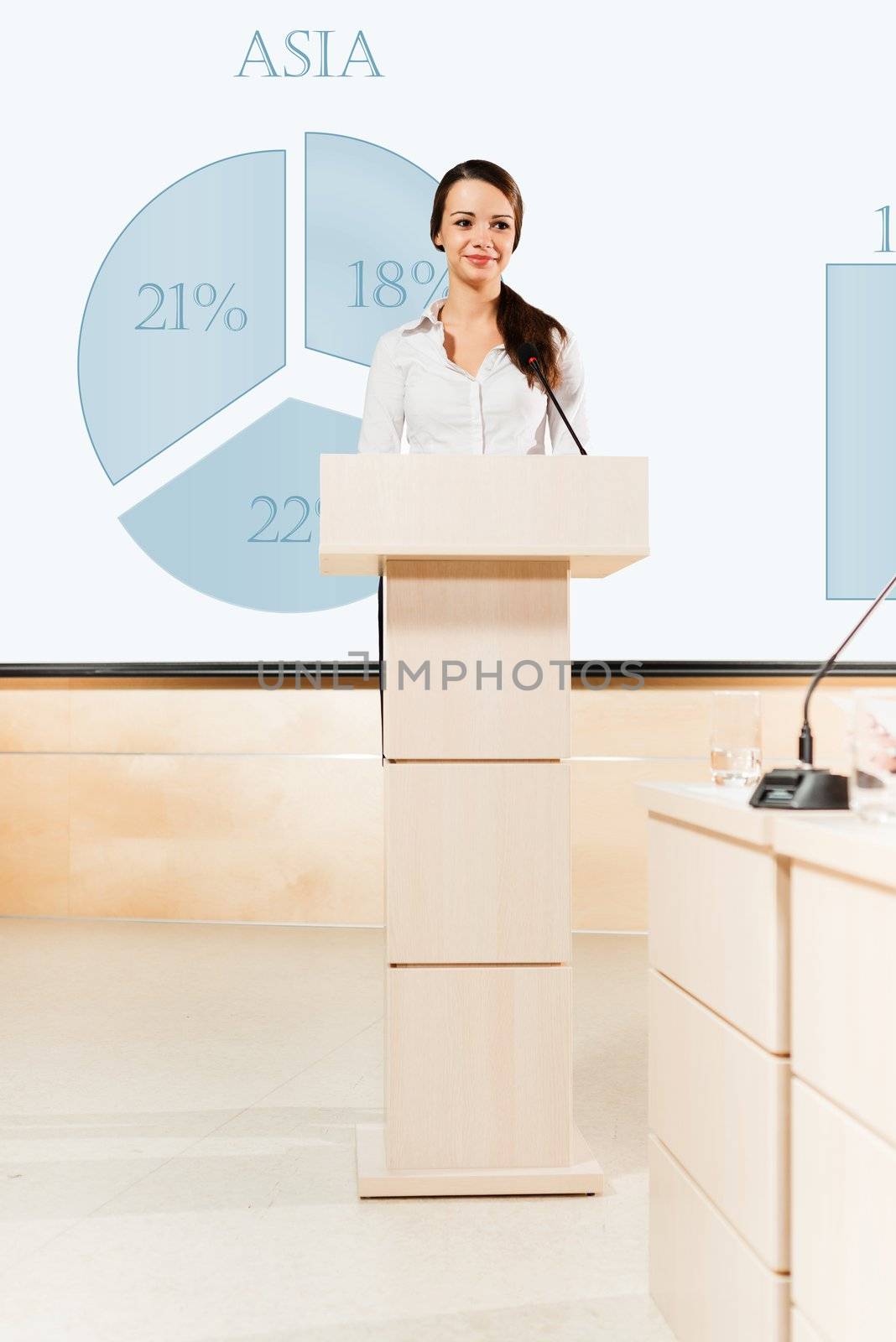 Business woman speaks into a microphone, communication businessmen at a conference