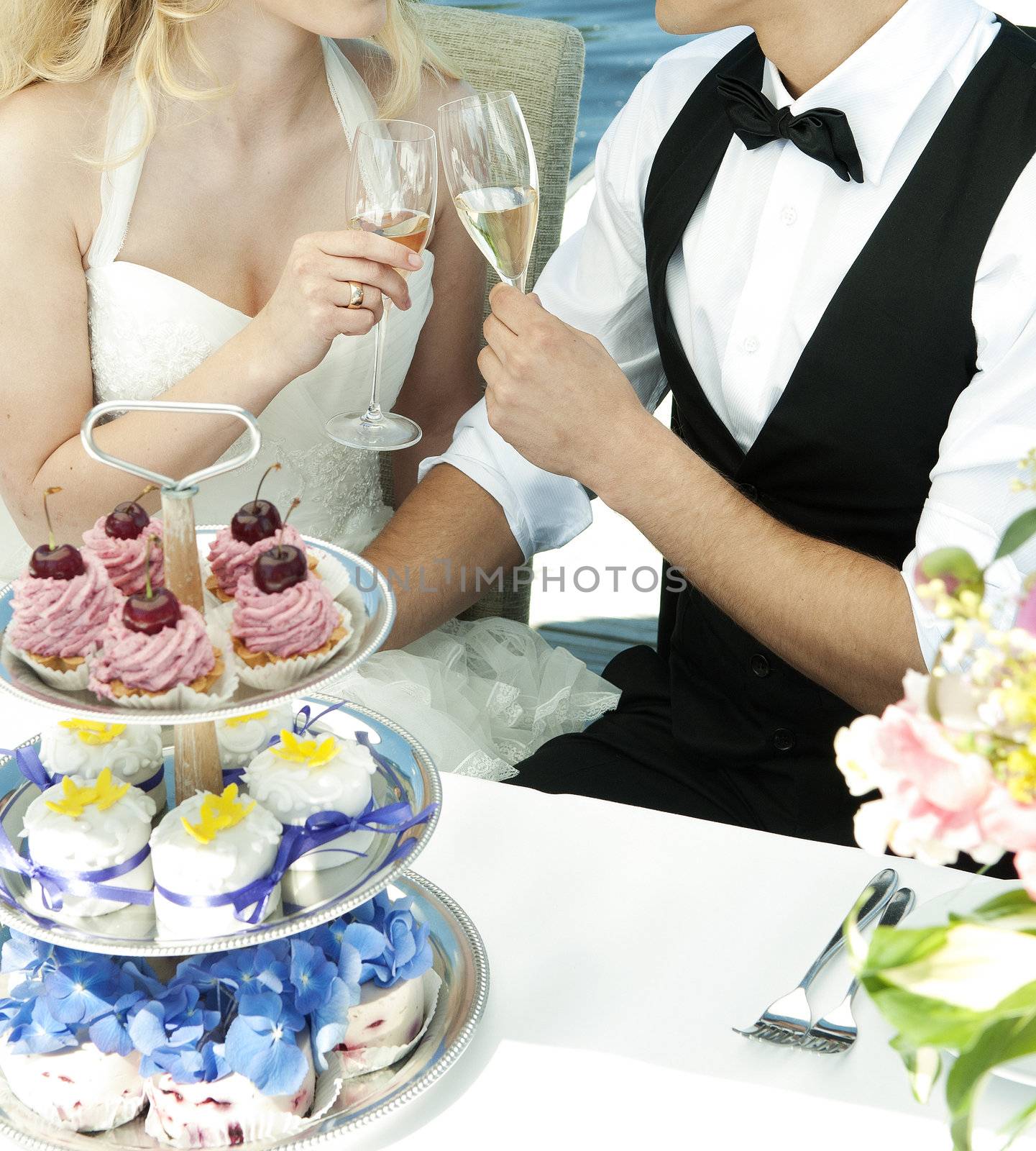 couple toasting at wedding by jackmalipan