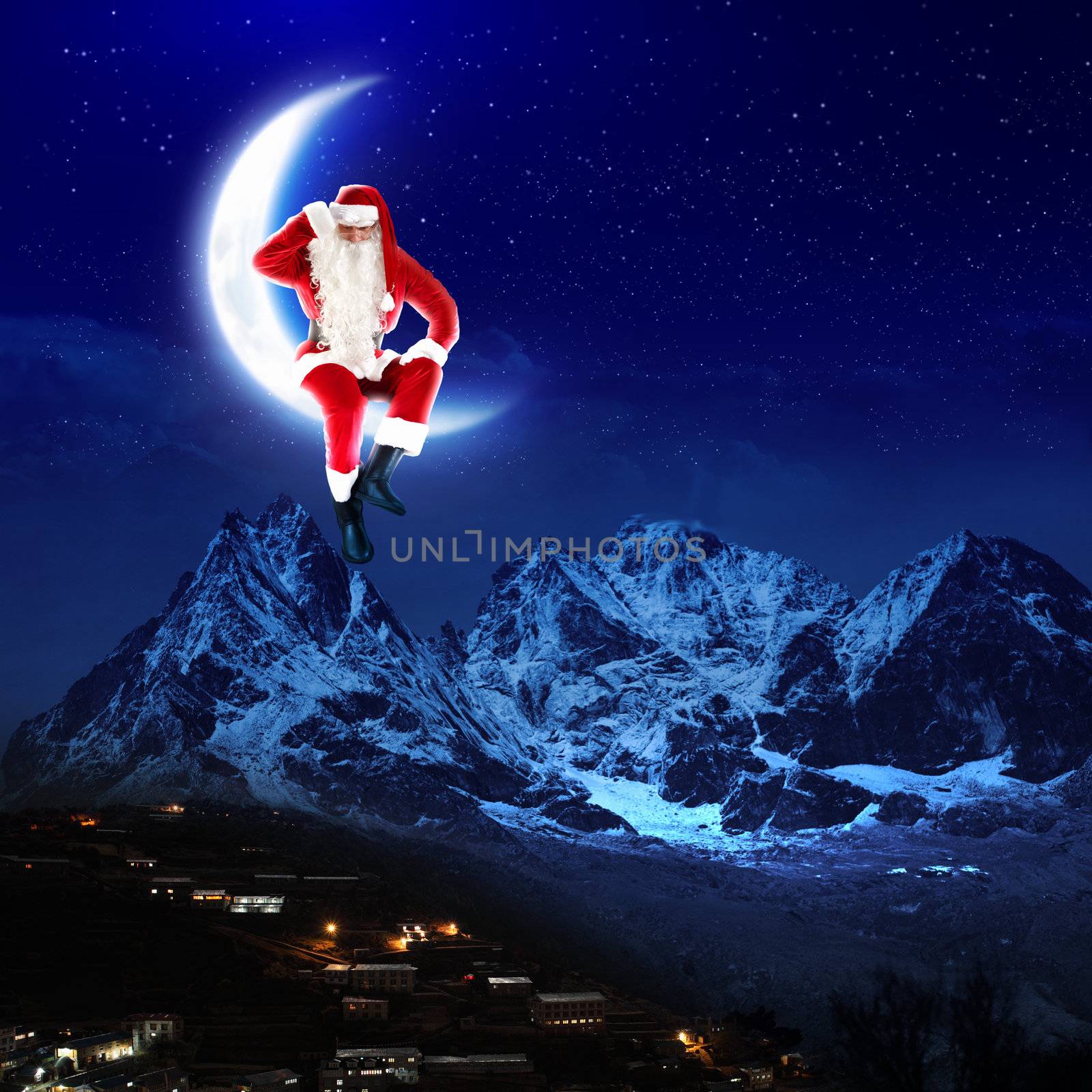 photo of santa claus sitting on the moon with a city and mountains below