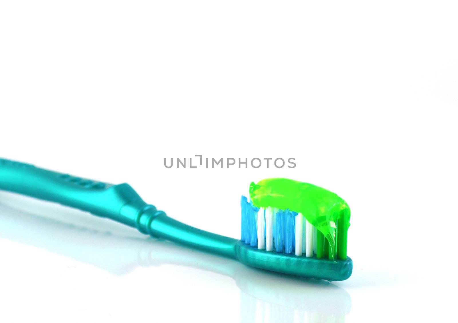 Tooth-brush with tooth paste over white  by sergpet