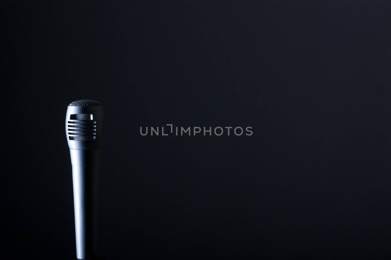 the single microphone on the dark background