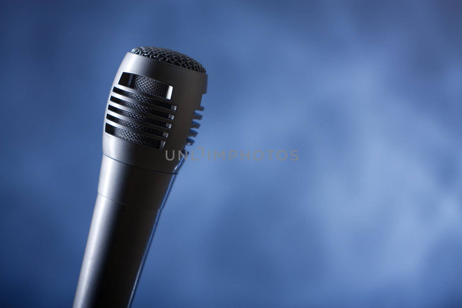 the single microphone on the dark background