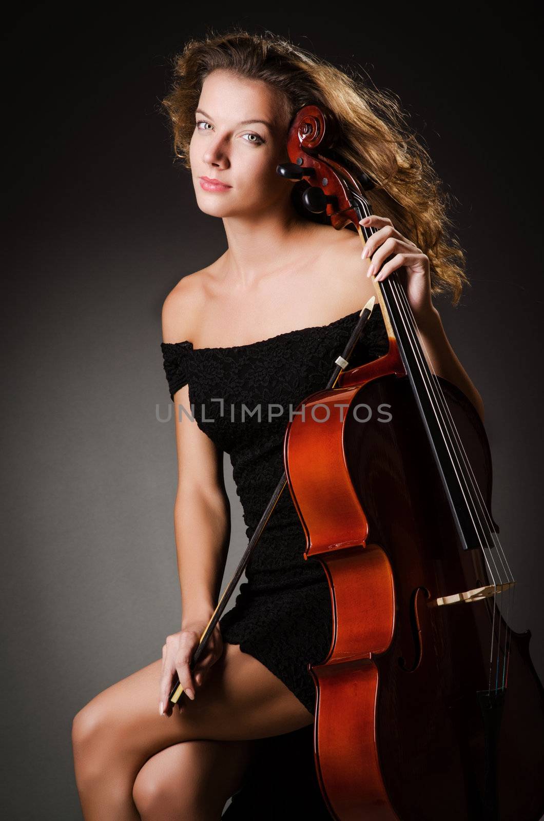 Woman performer with cello  in studio