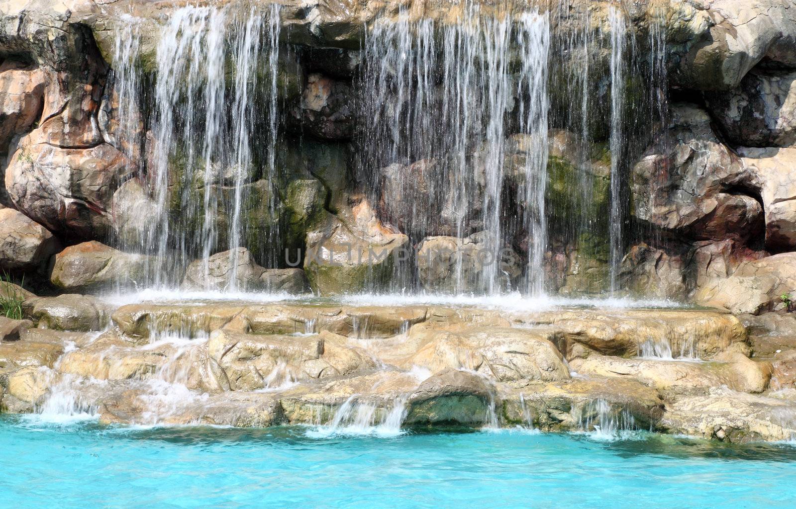 flowing waterfall in swimming pool by geargodz