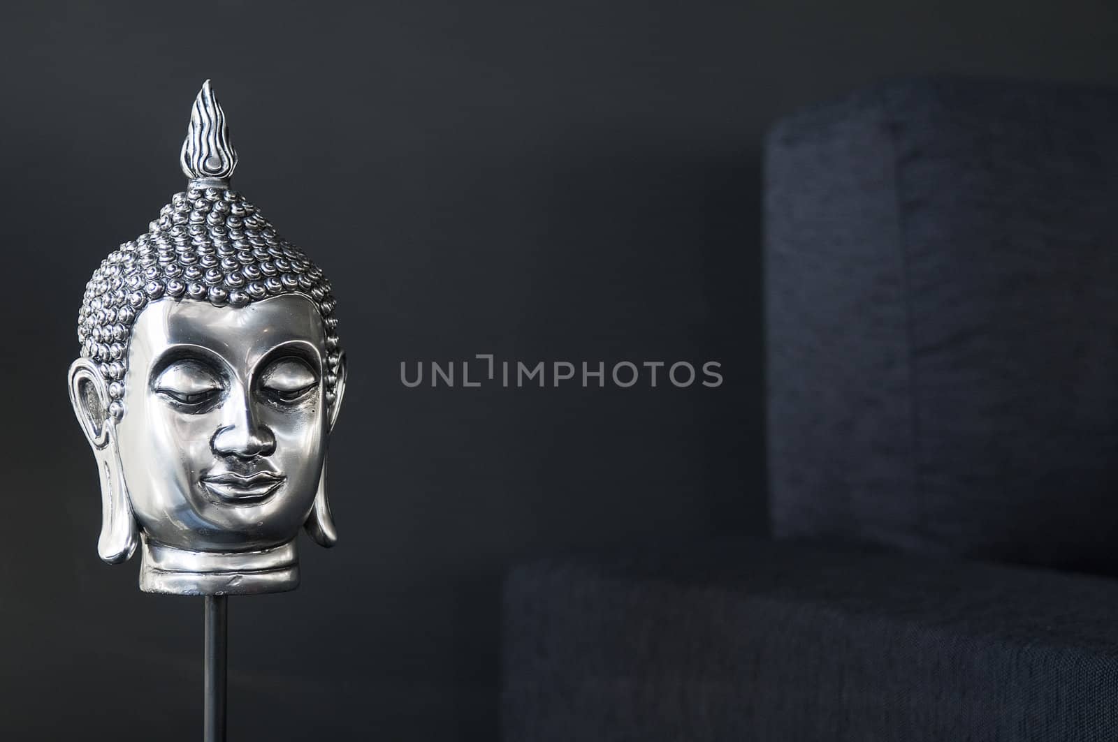 contemporary interior design detail with buddha image and sofa