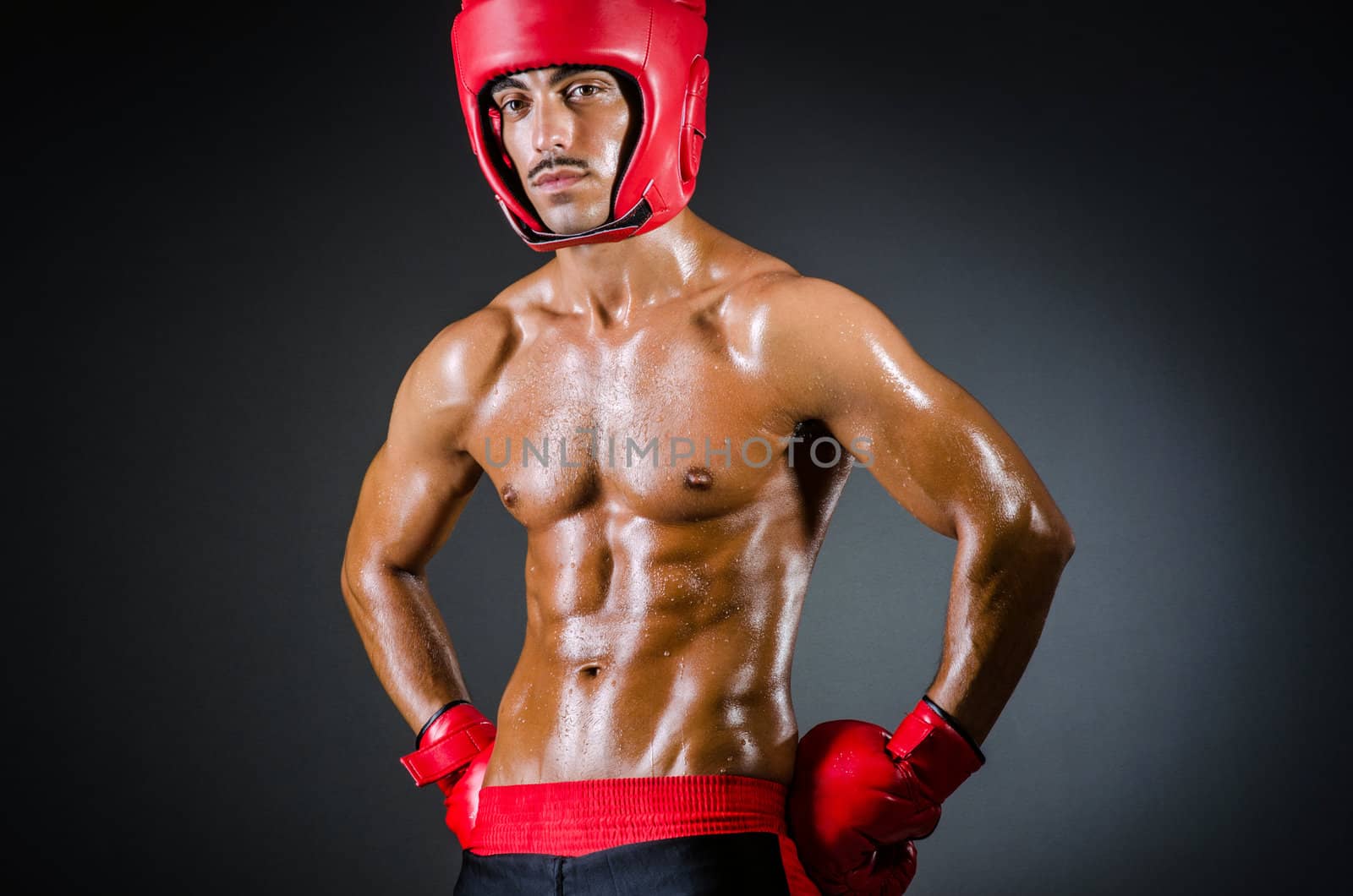 Muscular boxer in dark studio by Elnur