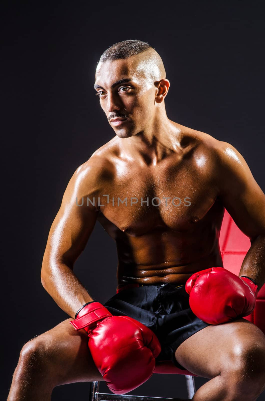 Boxer with red gloves in dark room by Elnur