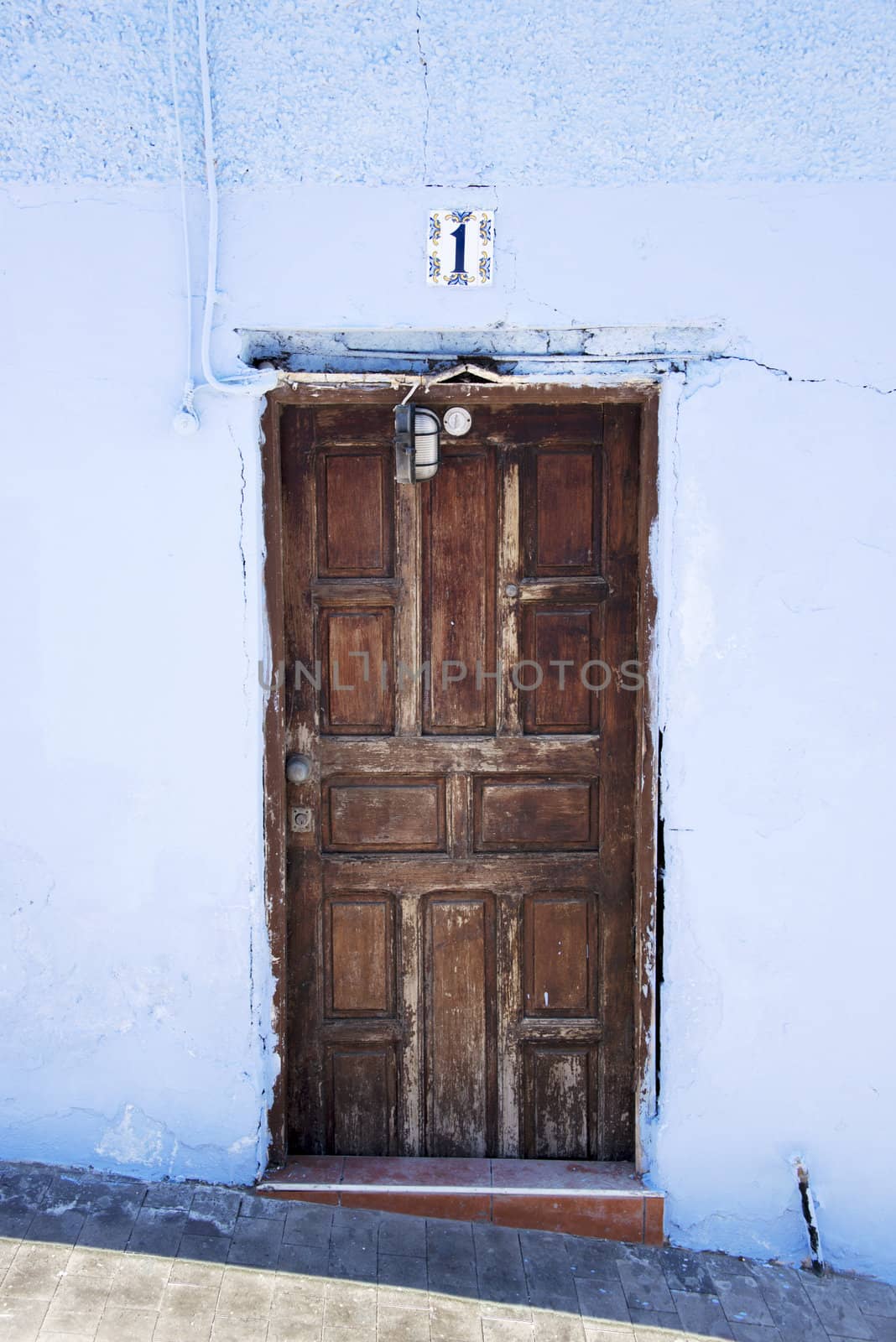 old wooden door with blue painted wall