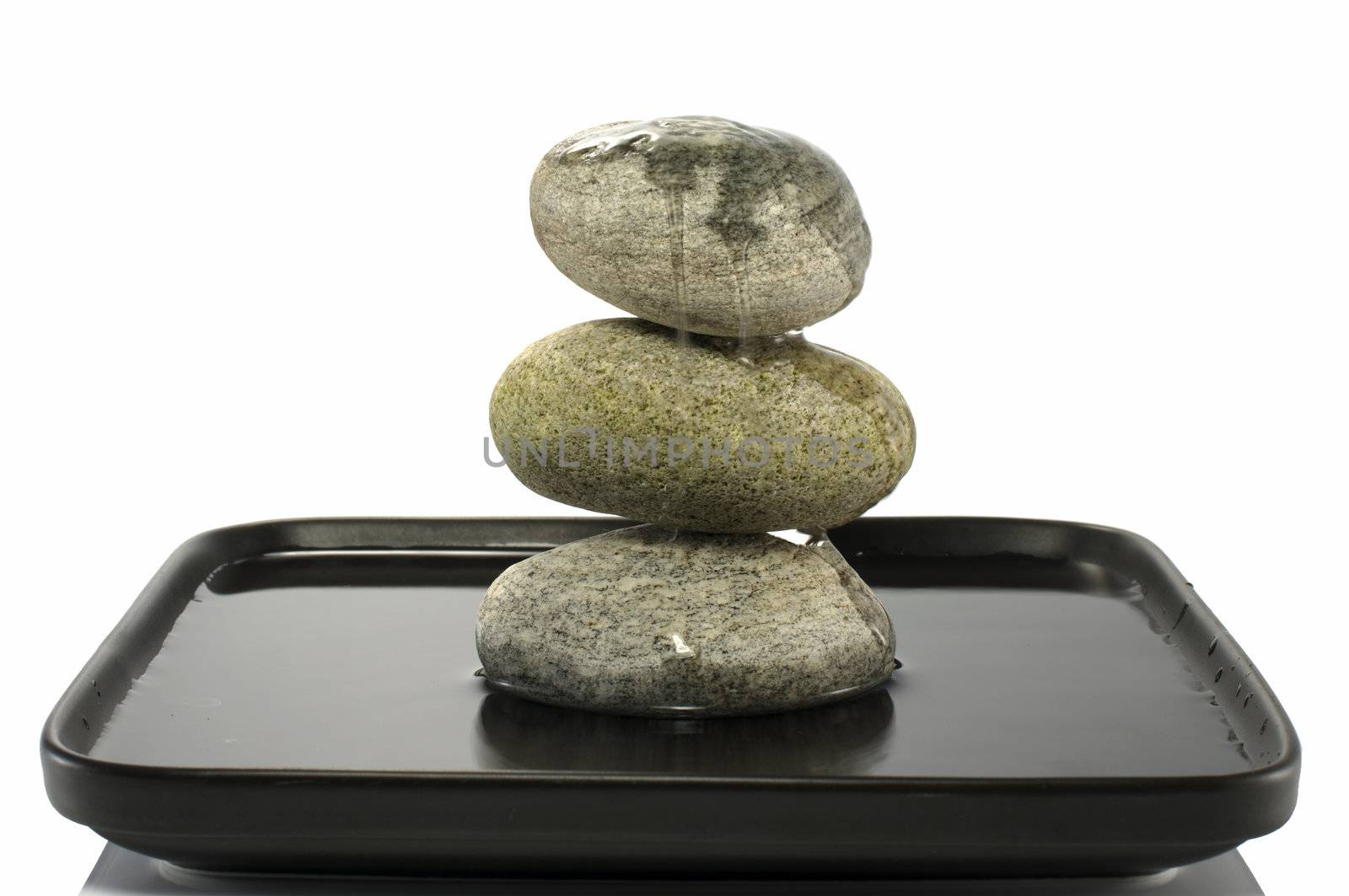 three stones in balance with water