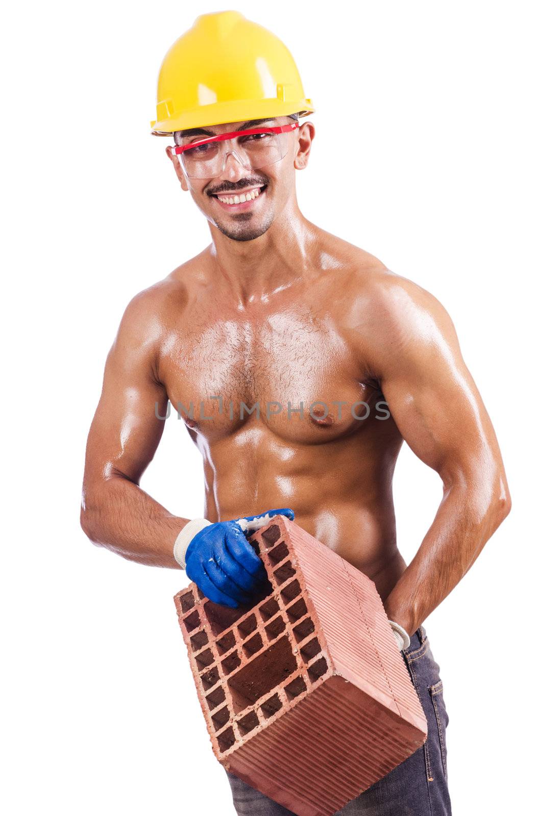 Muscular builder with bricks on white