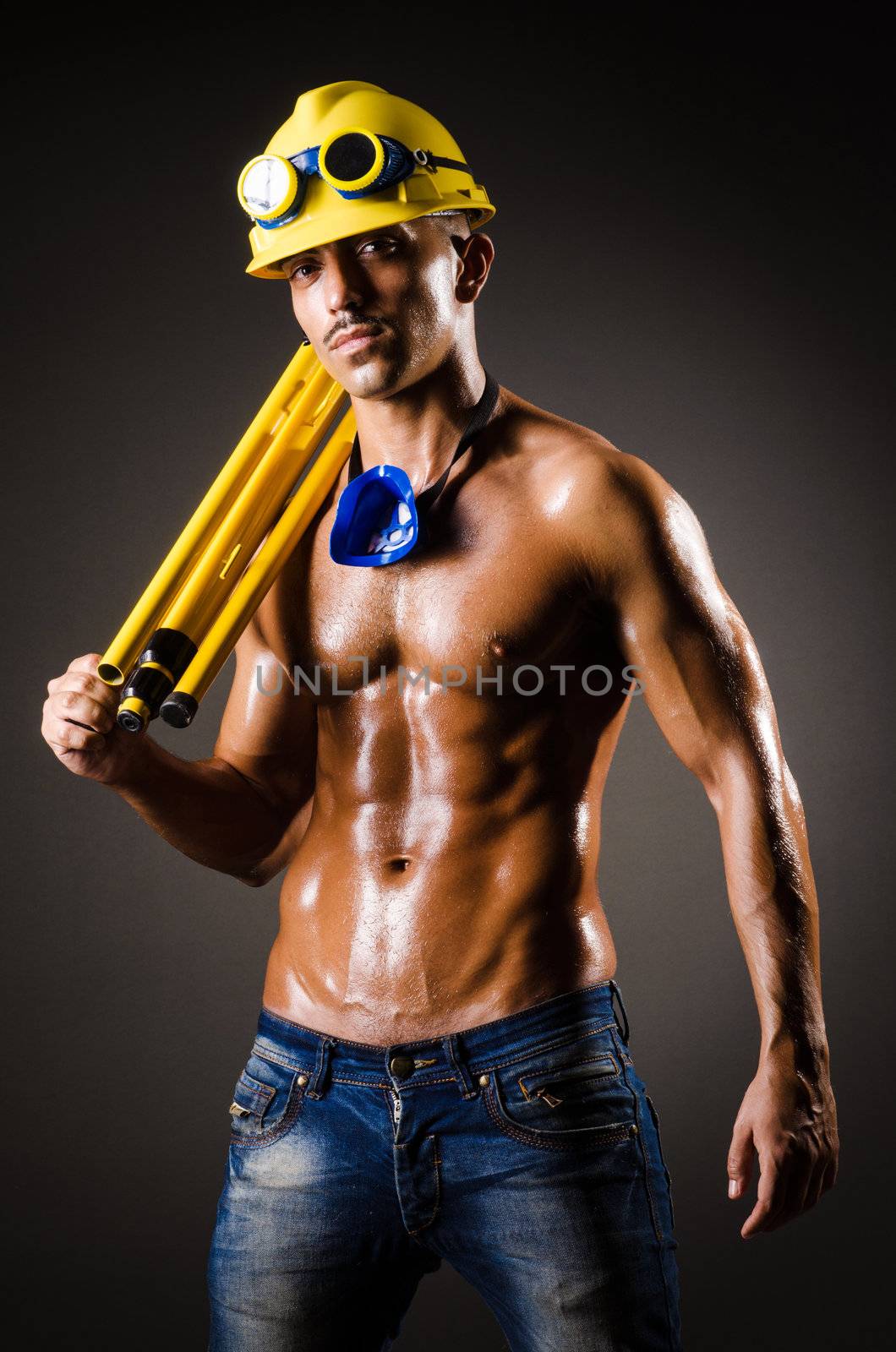 Construction worker in dark studio by Elnur