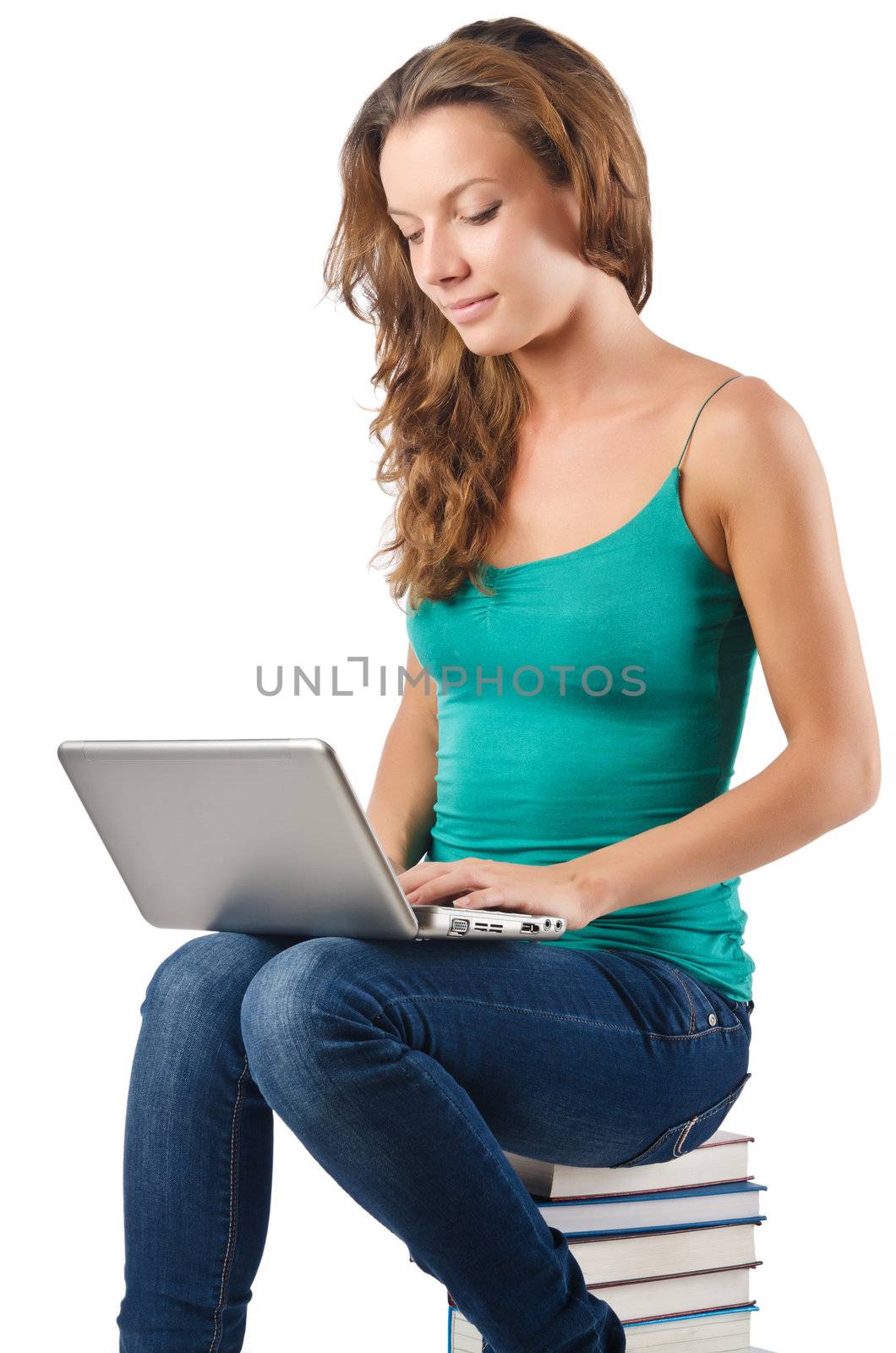 Student with netbook sitting on books by Elnur