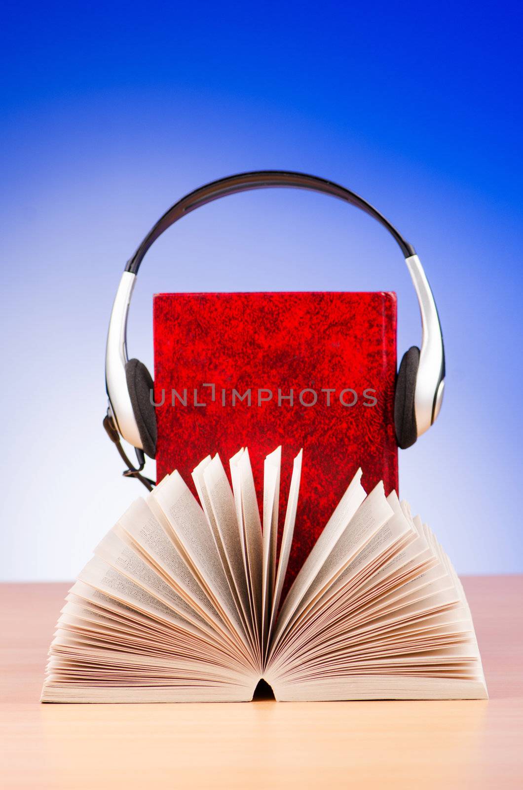 Concept of audio books with earphones on white by Elnur