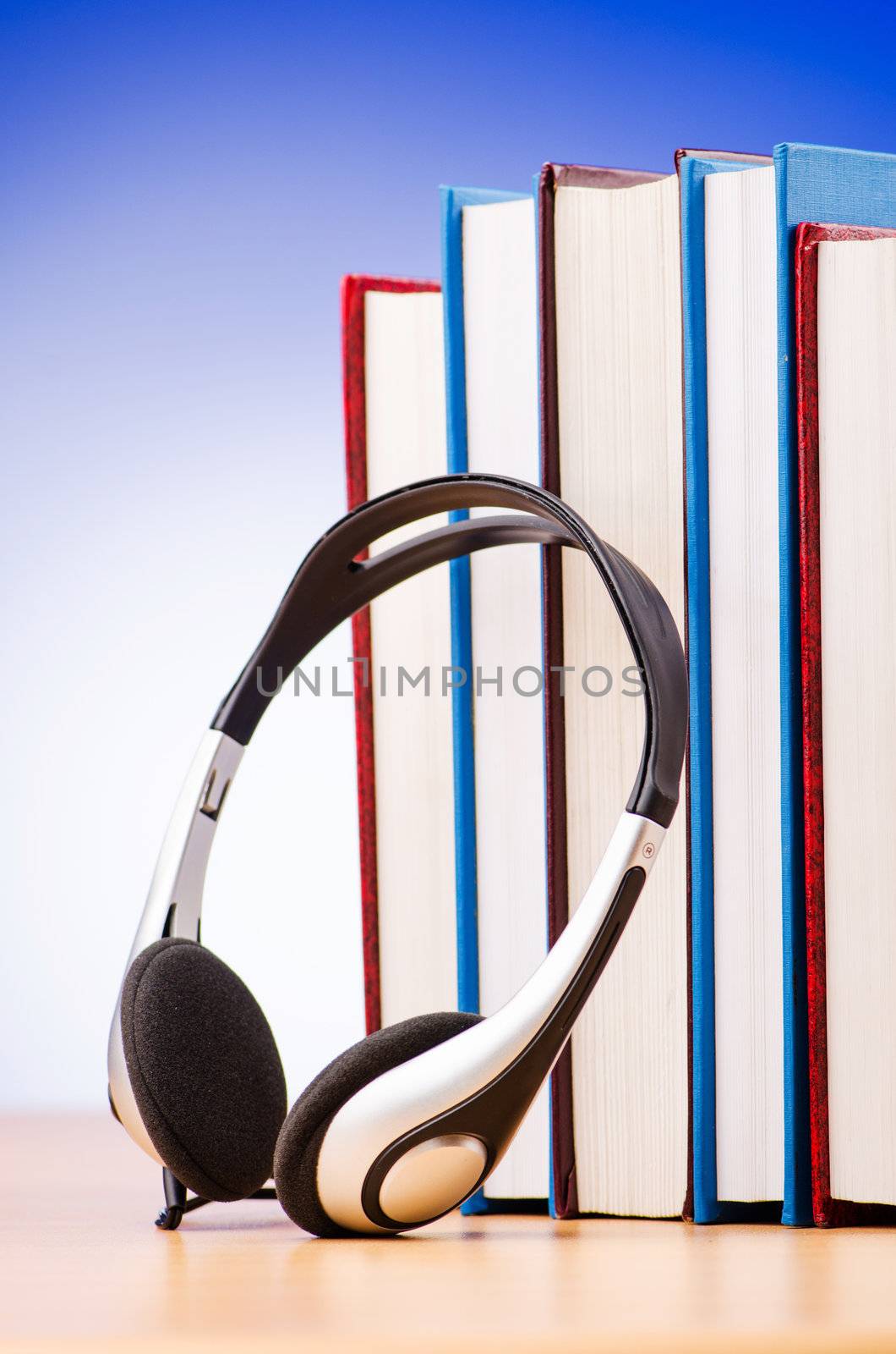 Concept of audio books with earphones on white by Elnur