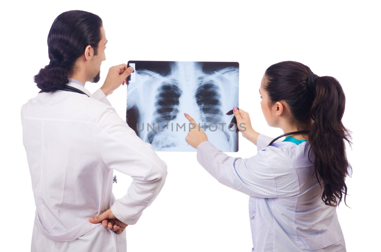 Two doctors looking at x-ray image on white by Elnur