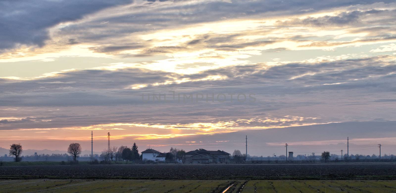 A Beatiful sunset over silhouettes of houses